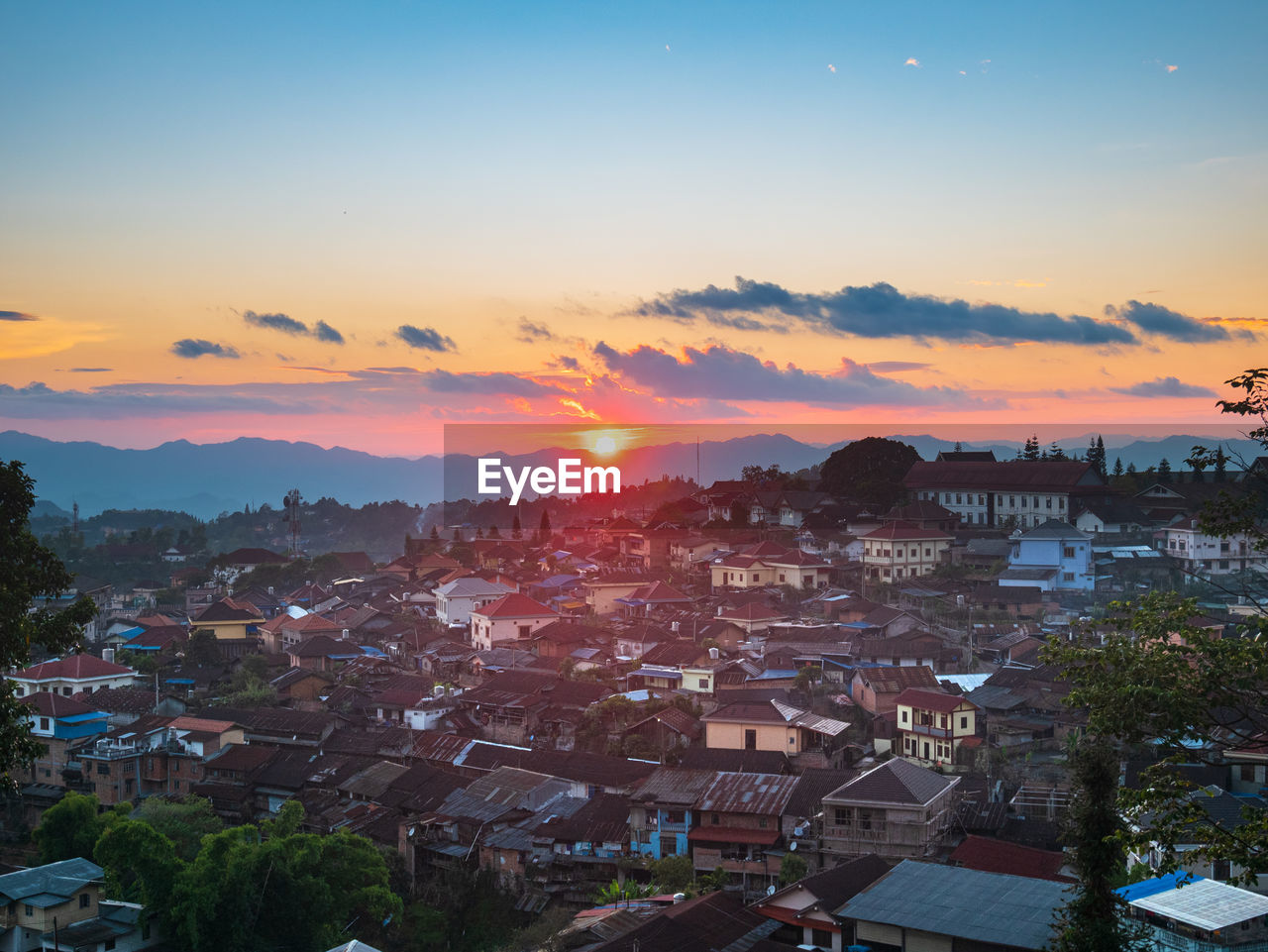 HIGH ANGLE SHOT OF TOWNSCAPE AGAINST SKY DURING SUNSET