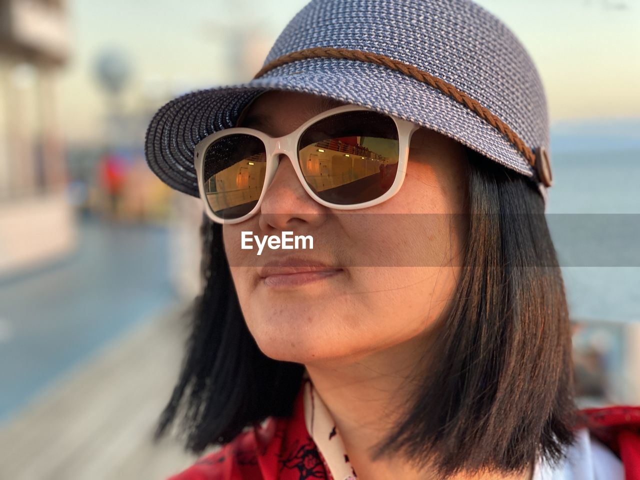 Close-up of woman wearing sunglasses standing outdoors