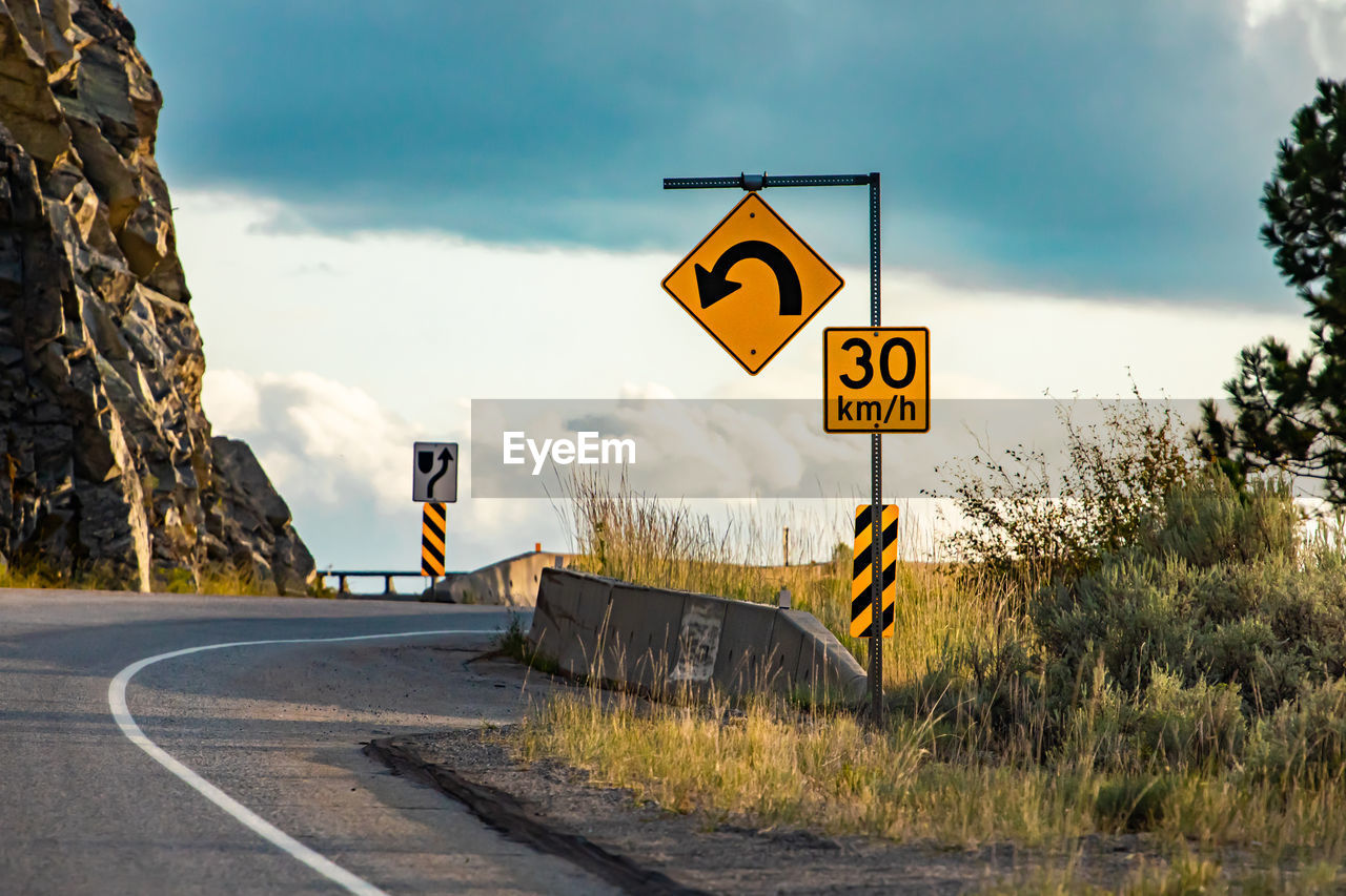 ROAD SIGN AGAINST TREES