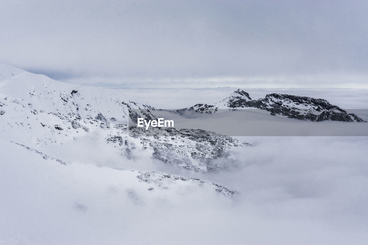 Scenic view of snow covered mountain against sky