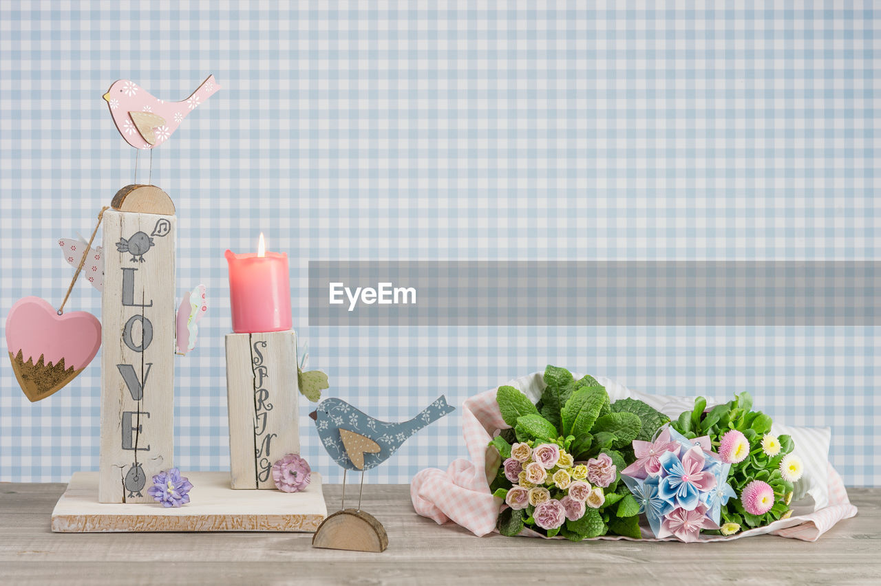 Homemade table decoration for the spring. english text love spring in lettering style.