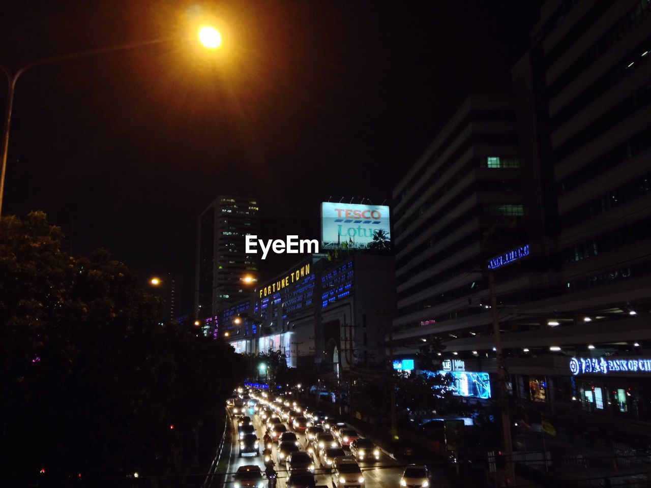 VIEW OF ILLUMINATED STREET AT NIGHT