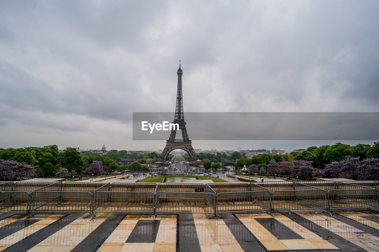 Eiffel tower against cloudy sky