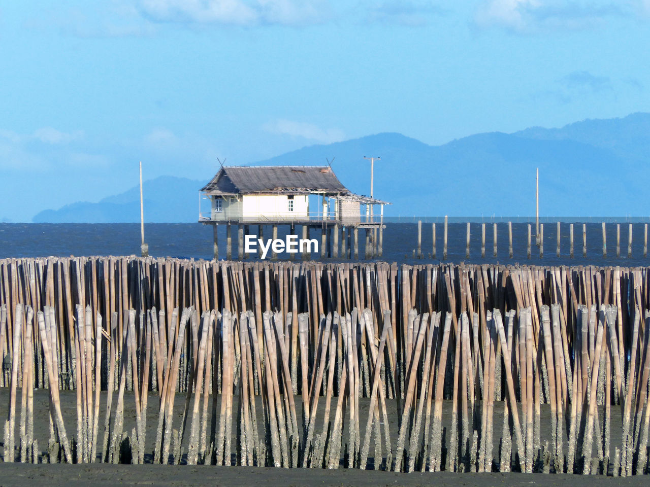 WOODEN PIER OVER SEA AGAINST SKY