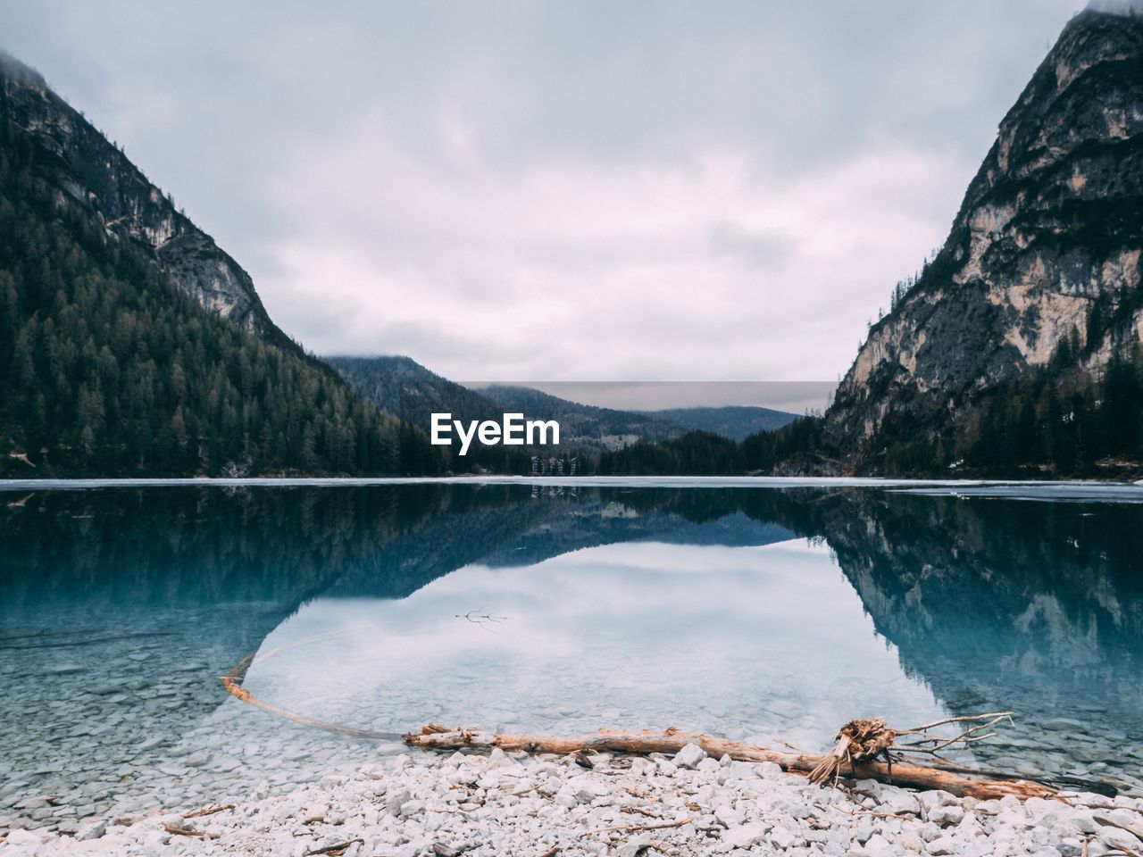 Scenic view of lake by mountains against sky