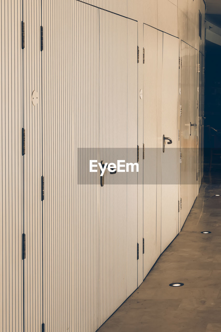 dressing room, locker room, locker, architecture, wall, floor, no people, building, protection, security, door, indoors, closed, wood, entrance, business, room, built structure, metal