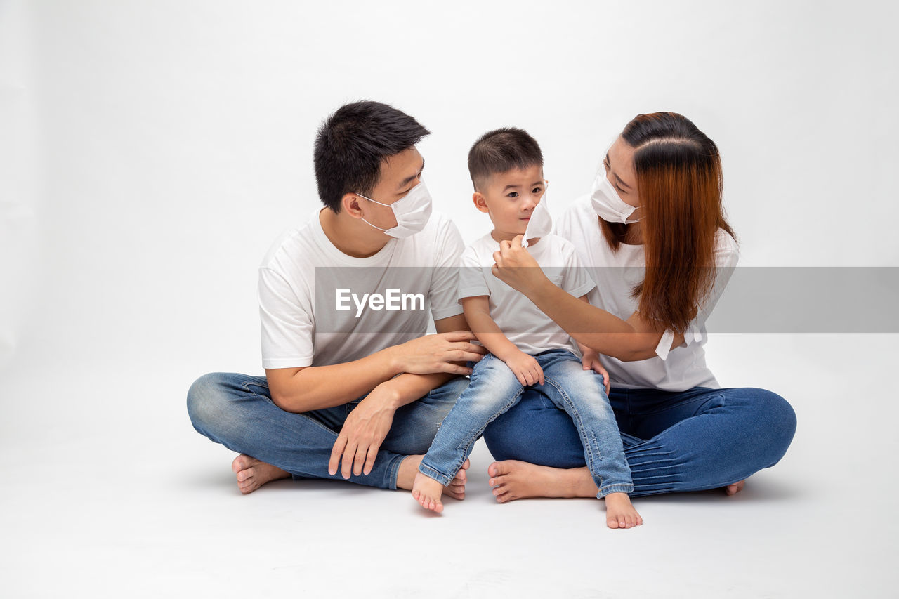 FRIENDS SITTING ON WHITE BACKGROUND