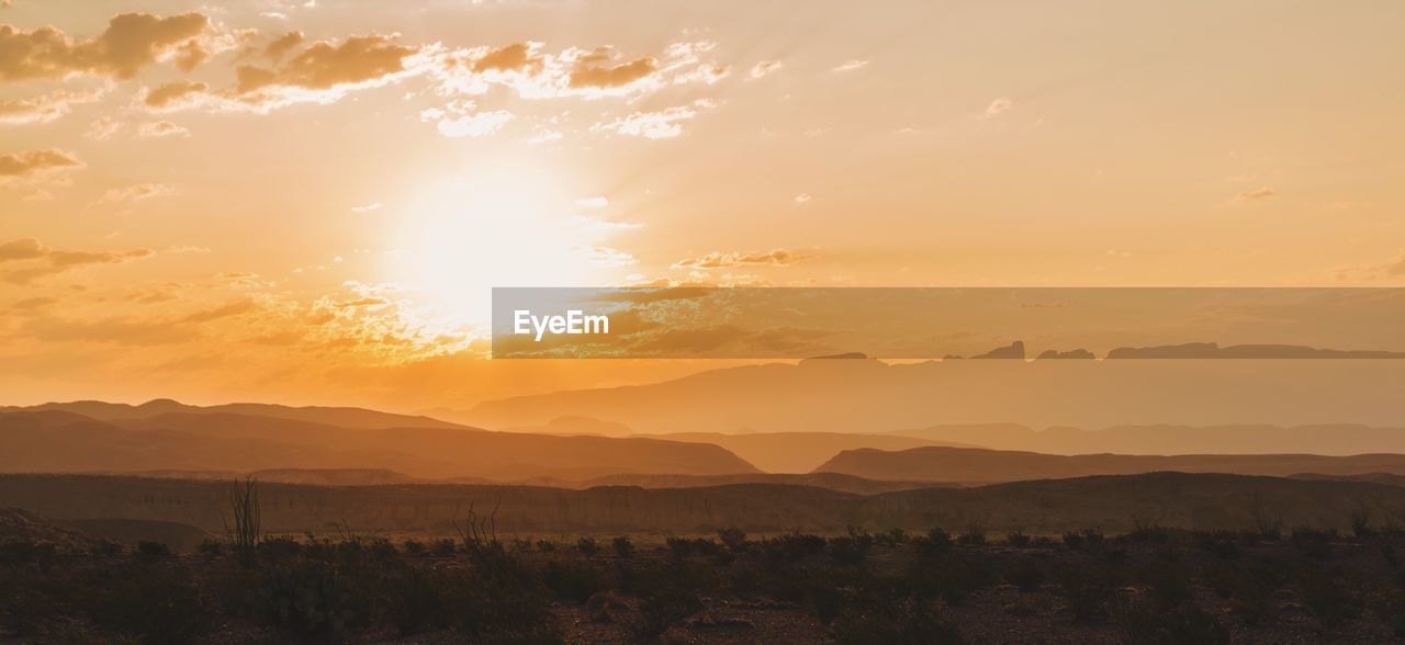 Scenic view of landscape against sky during sunset