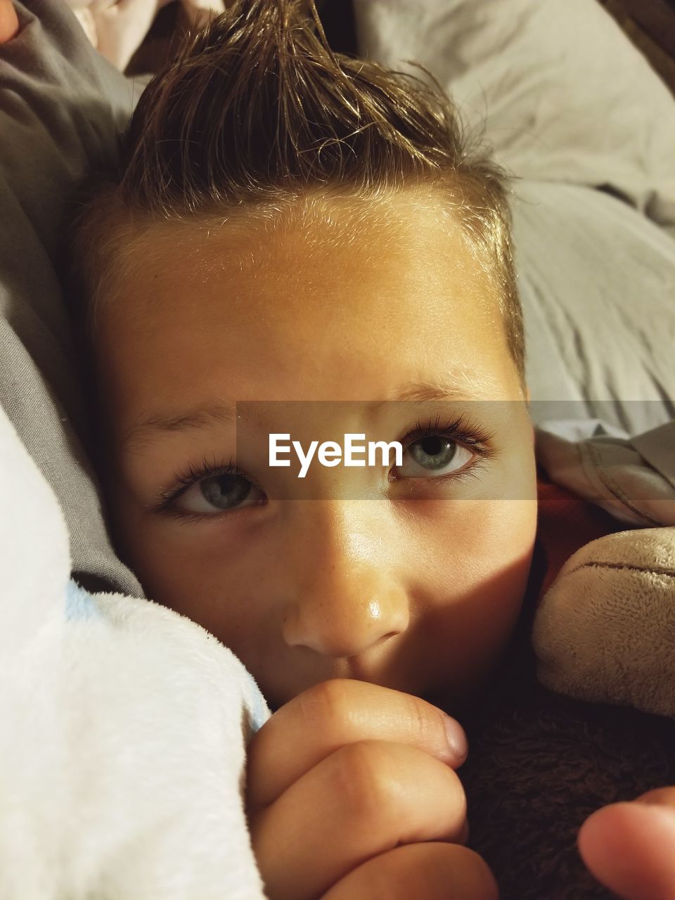 Close-up of boy lying on bed