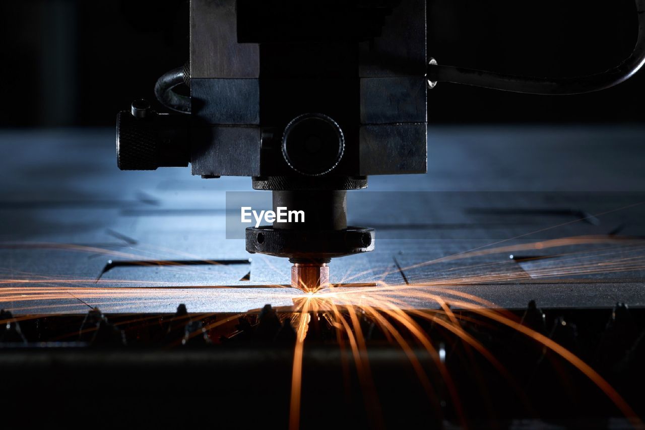 A photograph of a metal, laser-cutting machine.