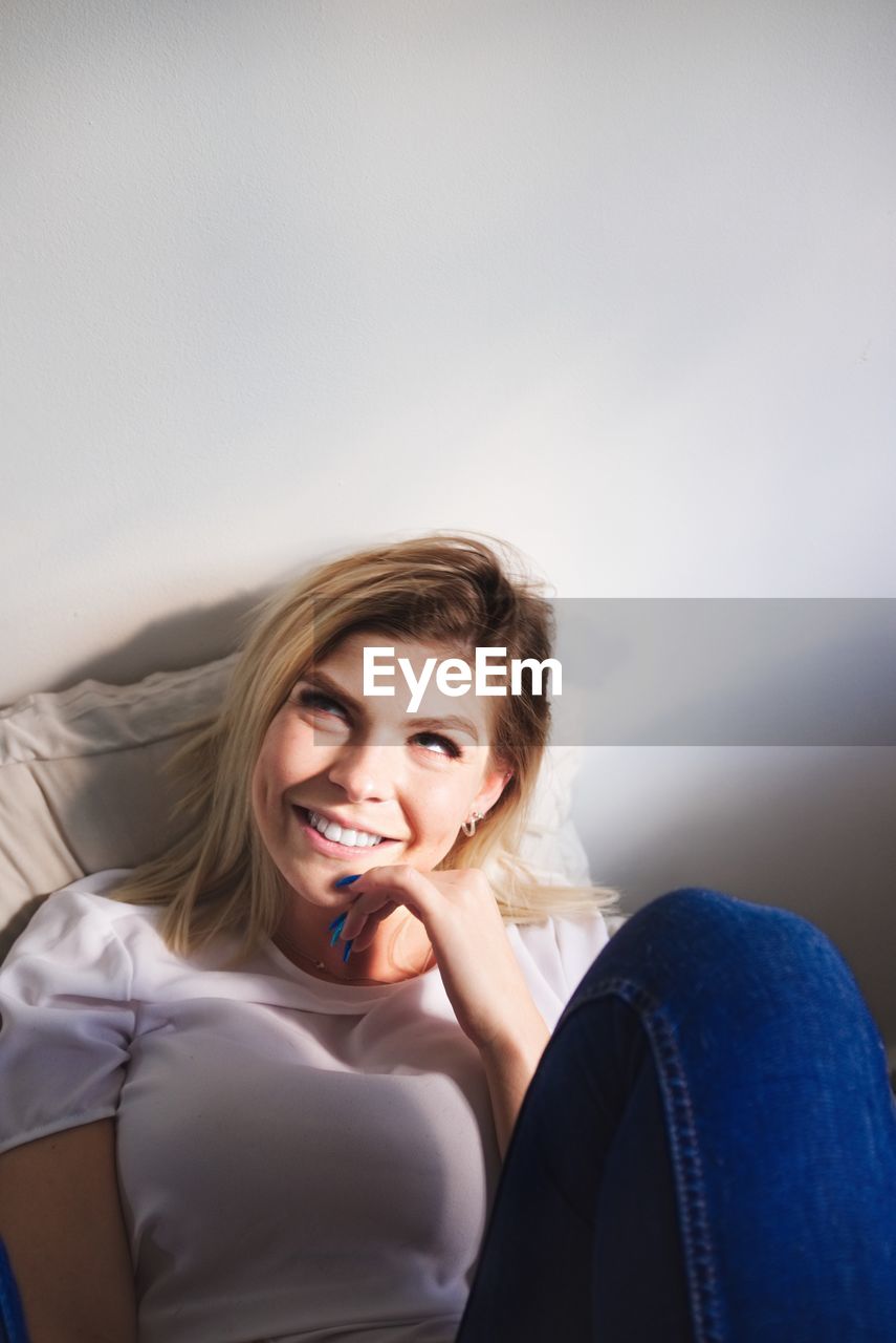 Smiling young woman relaxing at home