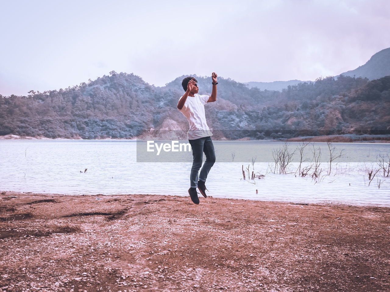 FULL LENGTH OF YOUNG WOMAN STANDING ON LAND