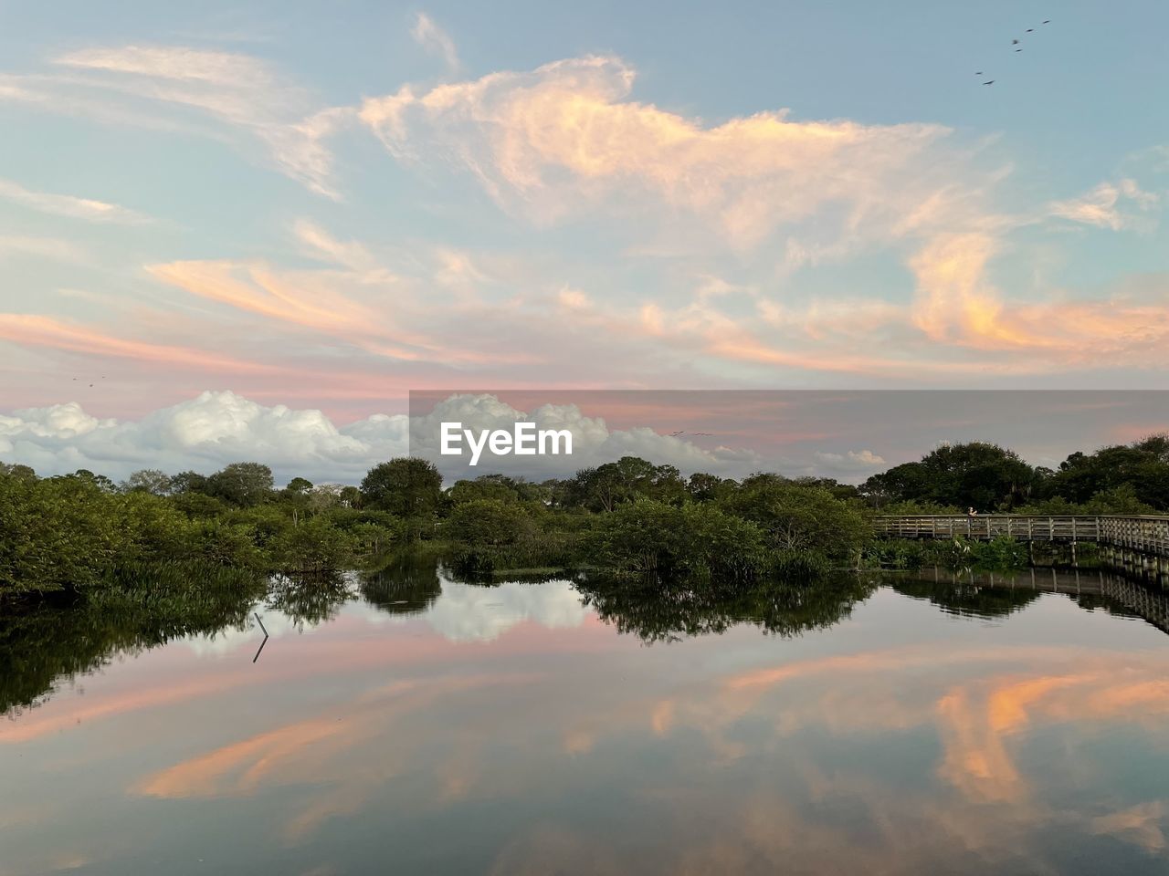 Scenic view of lake against sky during sunset