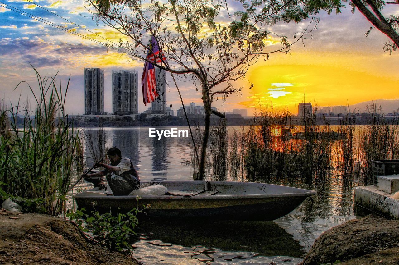 SCENIC VIEW OF LAKE AGAINST ORANGE SKY