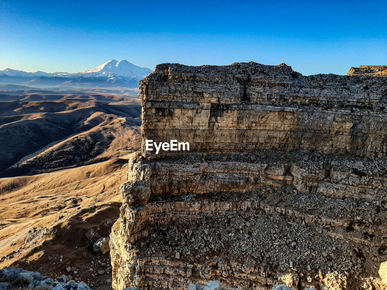 Scenic view of mountains against clear blue sky