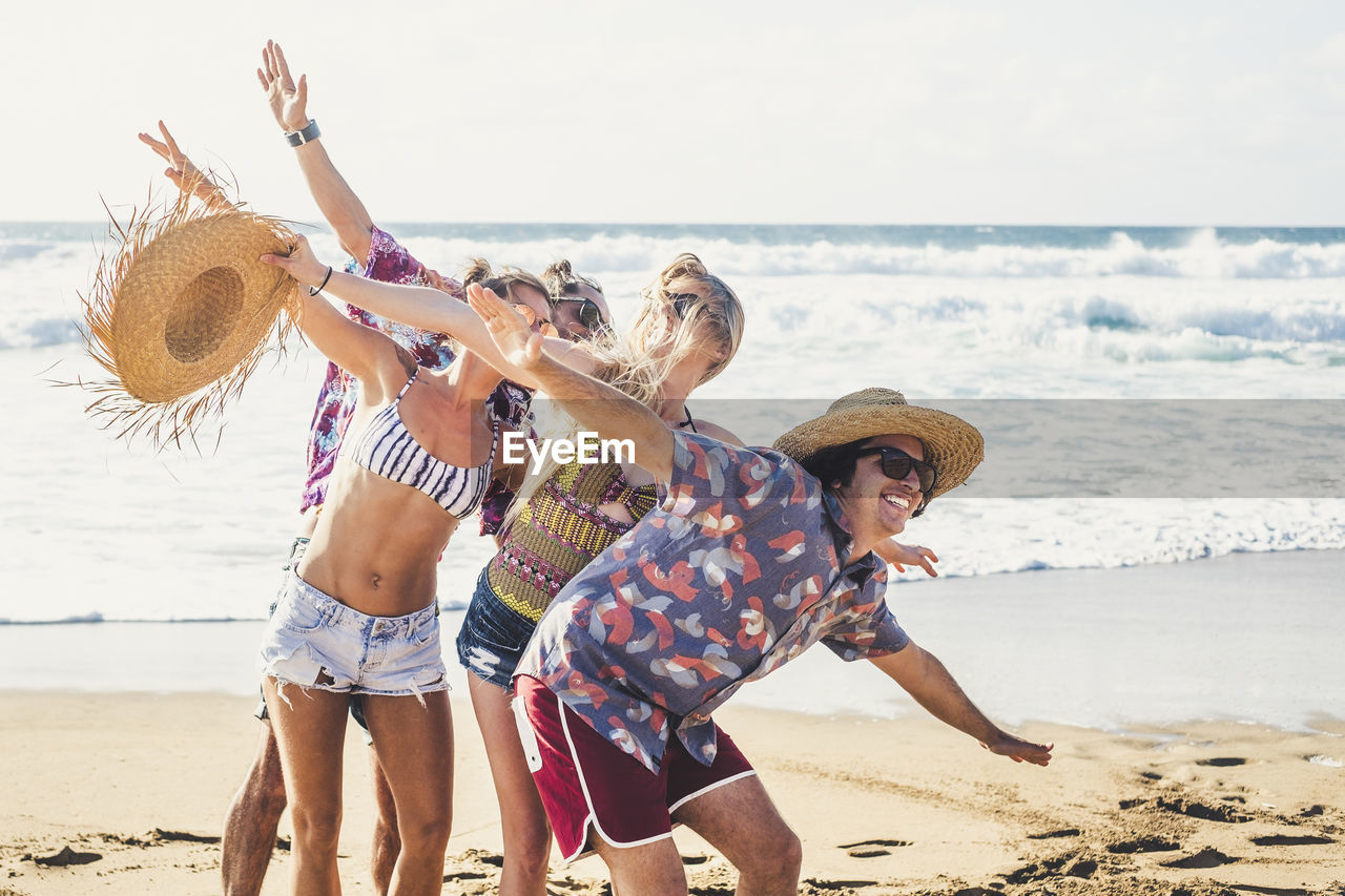 Cheerful friends enjoying on beach