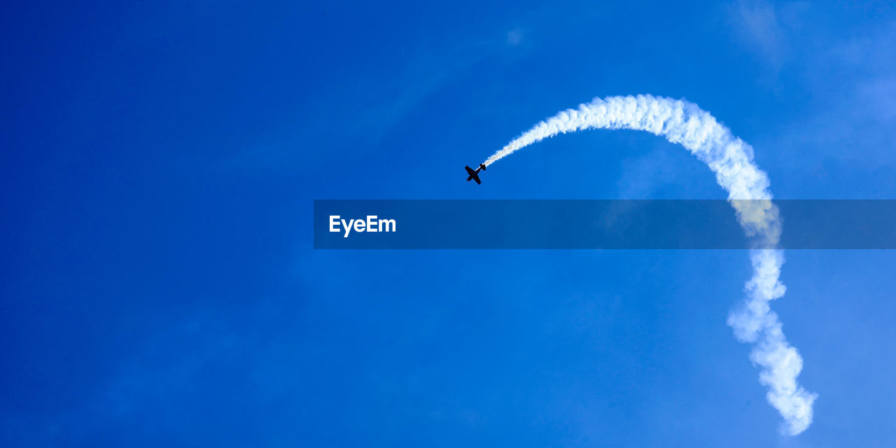 Overhead flying aircraft. aircraft in formation during an aerobatics display as they loop and roll 