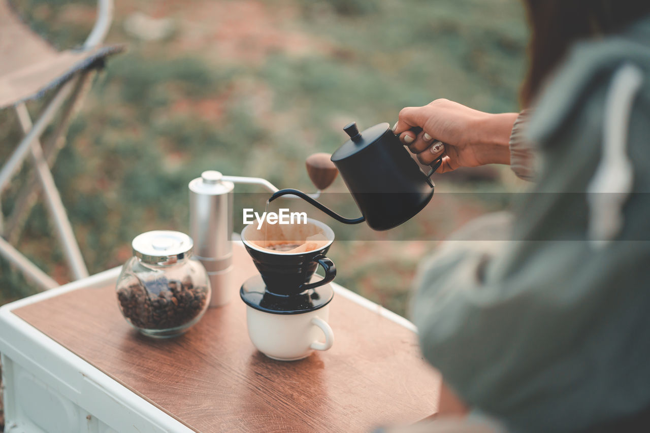 midsection of woman holding coffee