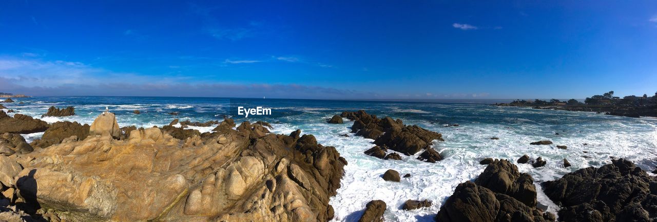 Panoramic view of sea against blue sky