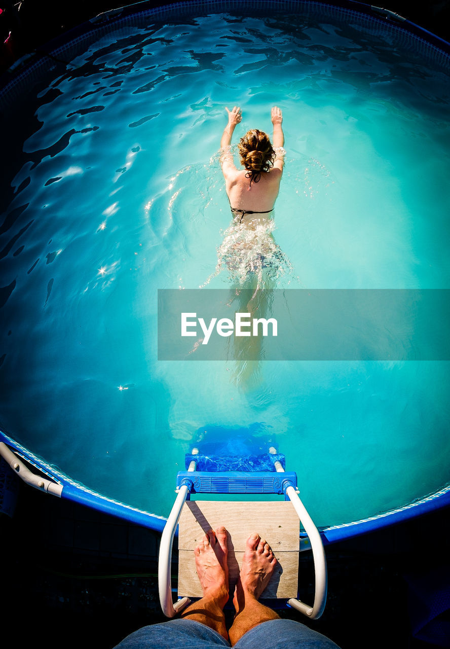 High angle view of woman swimming in pool
