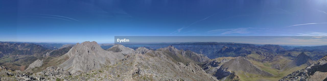 PANORAMIC VIEW OF MOUNTAINS AGAINST BLUE SKY