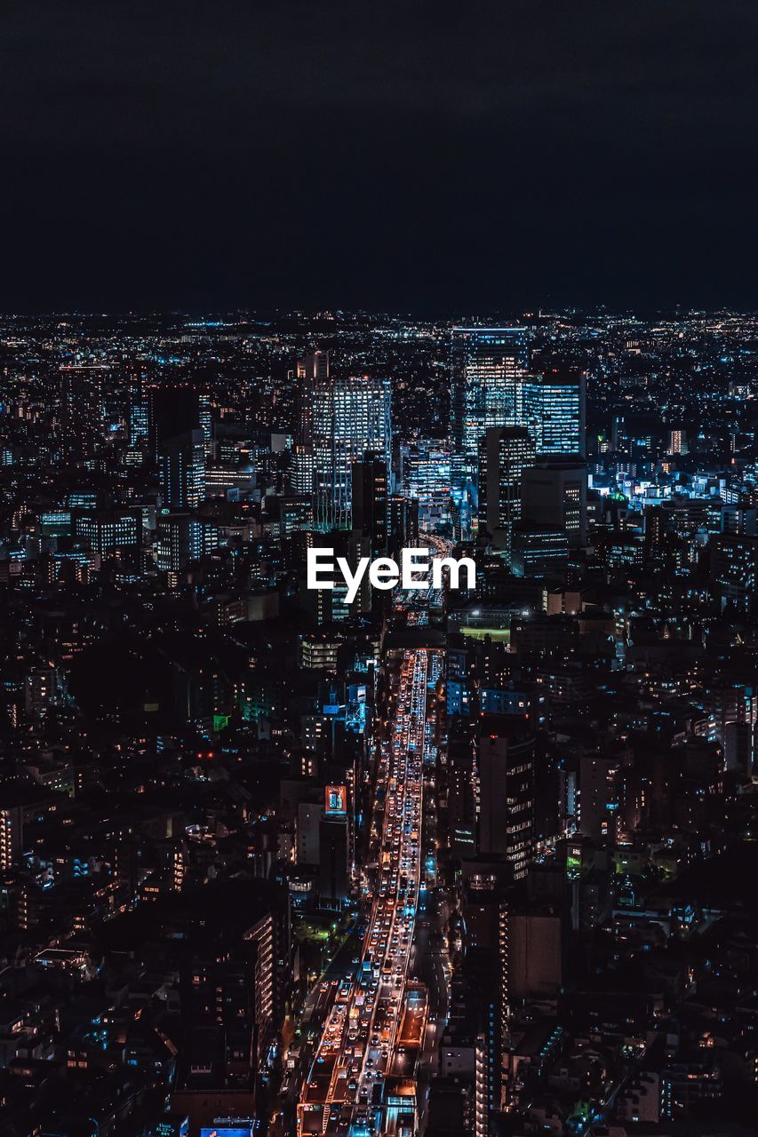 High angle view of illuminated cityscape against sky at night