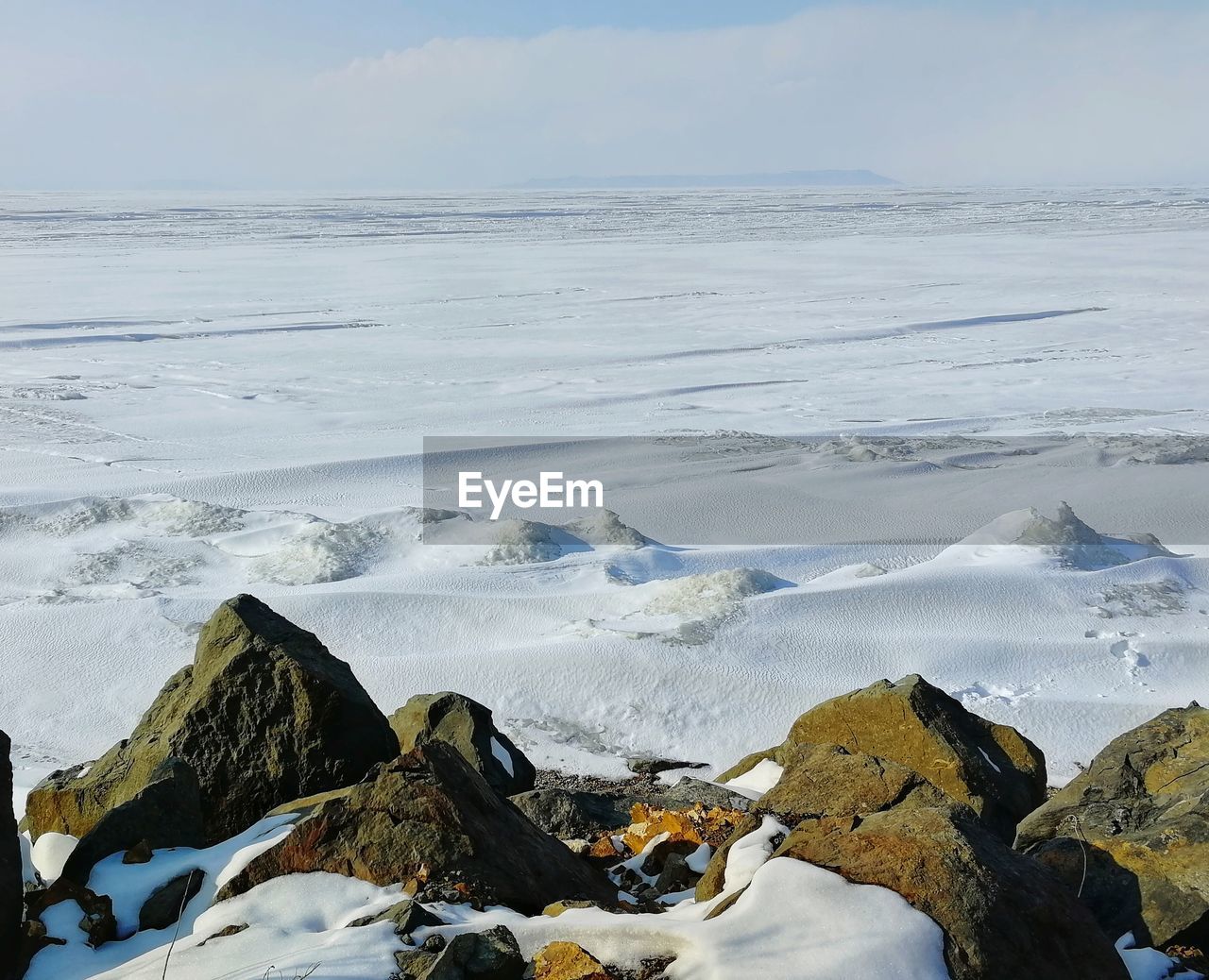 Frozen amur bay in japanese sea against the sky during winter day