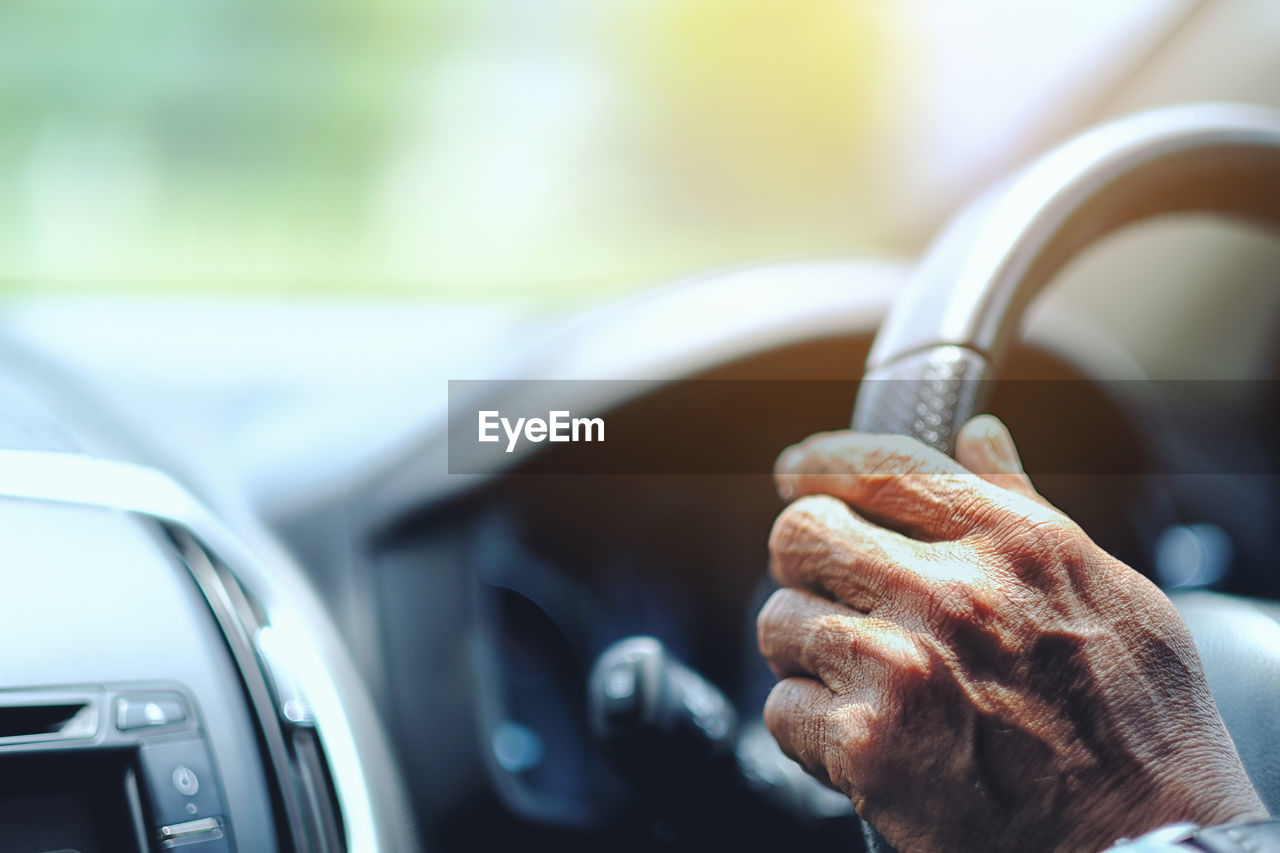 Cropped image of man driving car