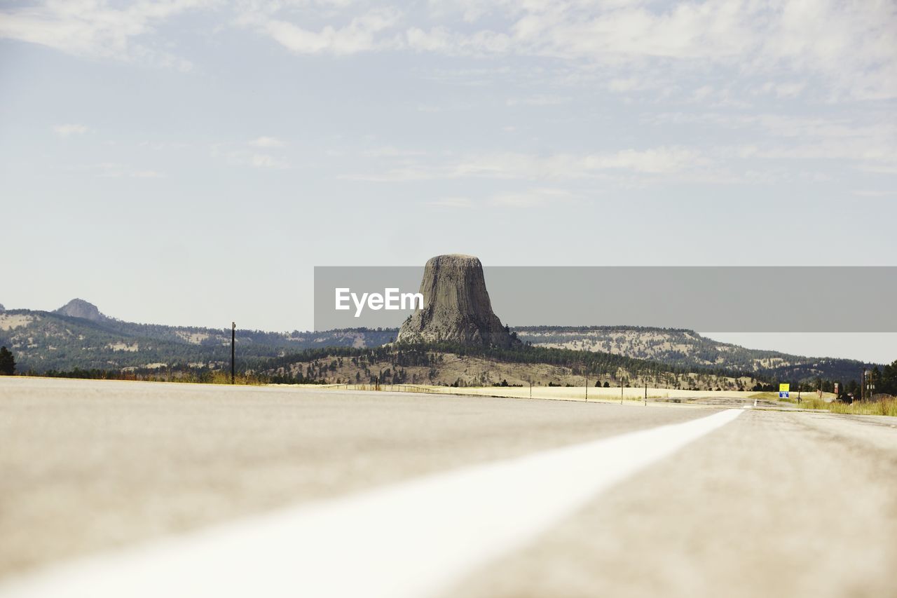 Road by mountain against sky