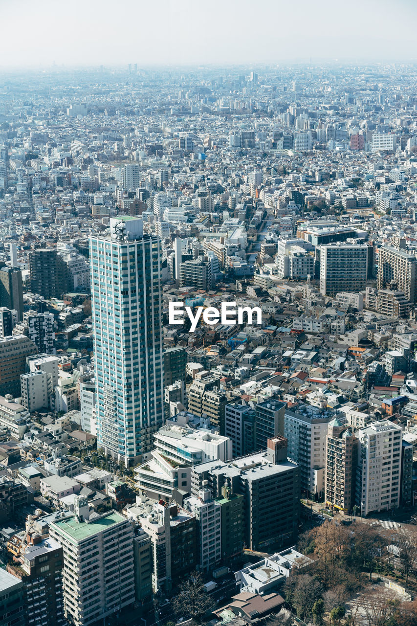 High angle view of modern buildings in city against sky