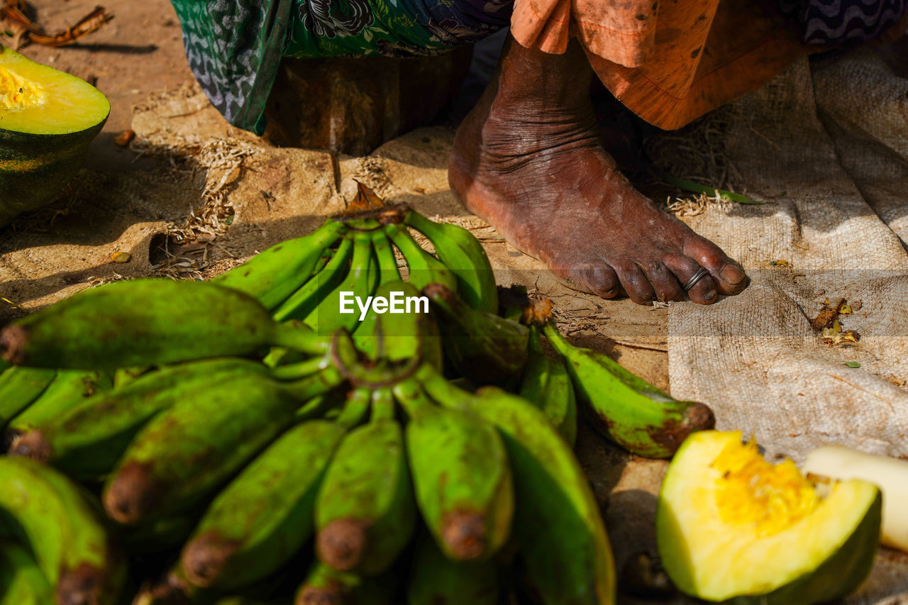 LOW SECTION OF MAN WORKING ON MARKET STALL