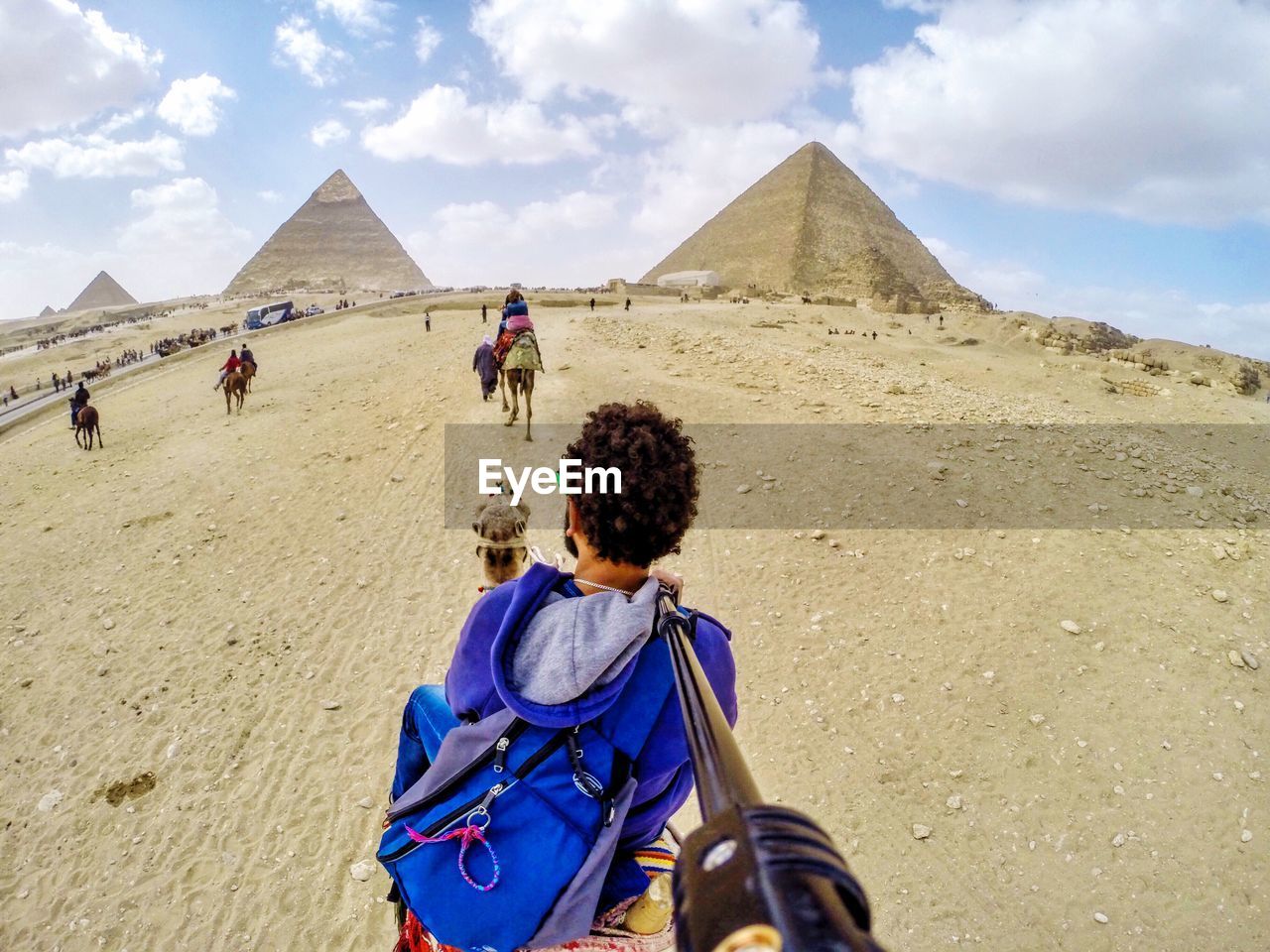 REAR VIEW OF MAN AND WOMAN STANDING ON DESERT