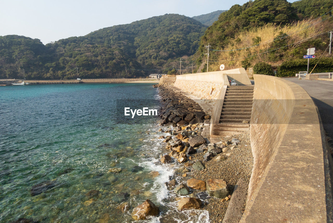 water, coast, sea, land, shore, nature, scenics - nature, mountain, beach, reservoir, body of water, sky, environment, beauty in nature, transportation, travel destinations, vacation, travel, no people, day, coastline, tree, tranquility, landscape, tranquil scene, architecture, outdoors, tourism, bay, rock, sunny, terrain, holiday, sunlight, plant, idyllic, non-urban scene, clear sky, trip