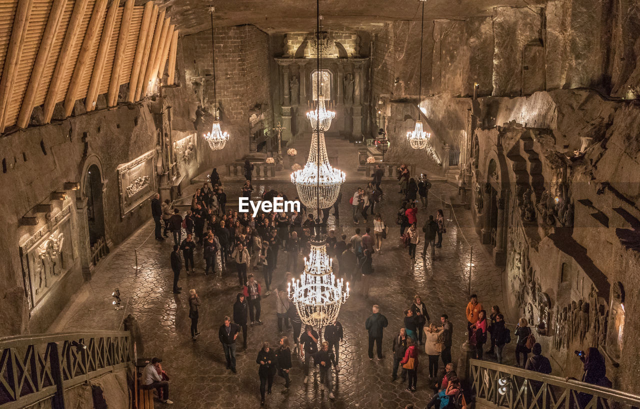 PEOPLE IN ILLUMINATED BUILDING