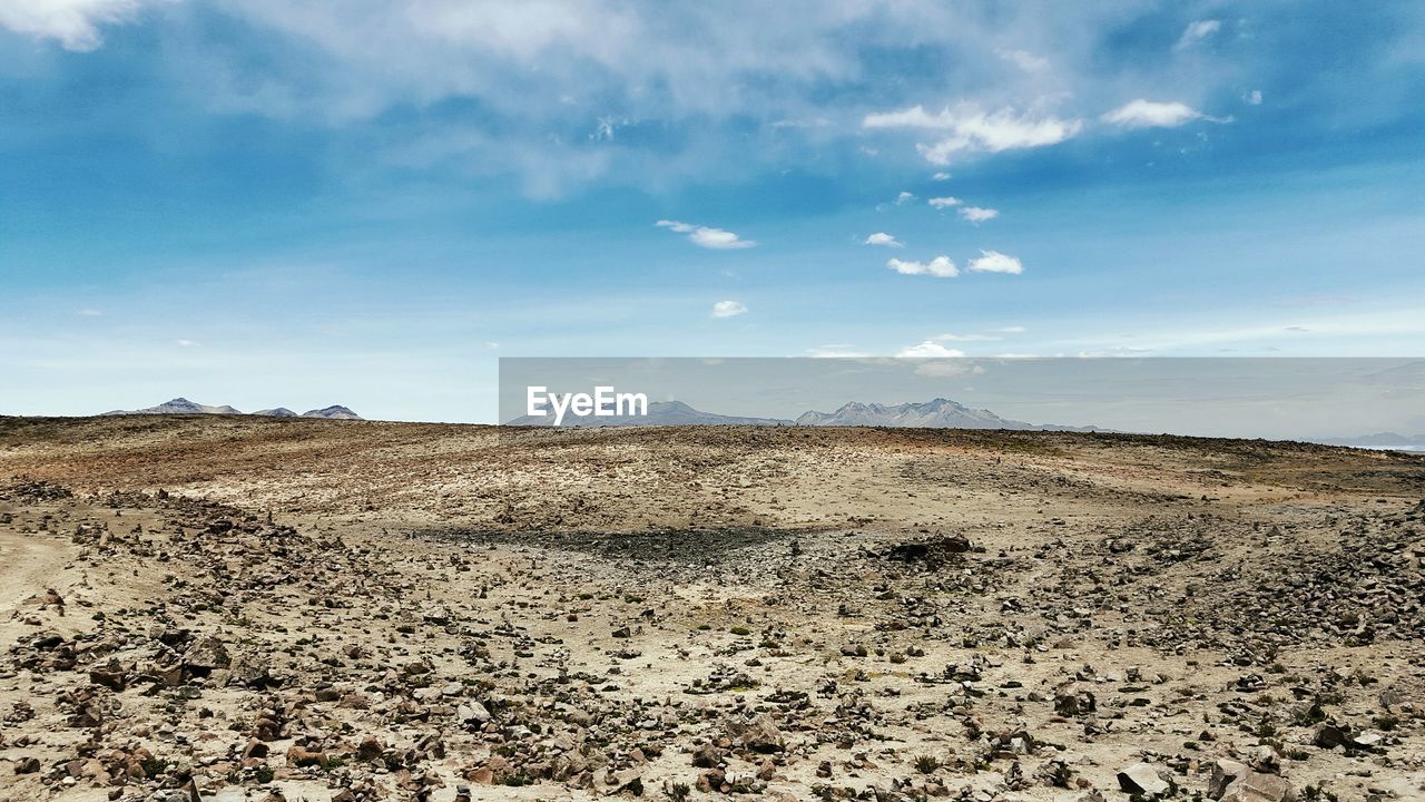 Scenic view of landscape against cloudy sky