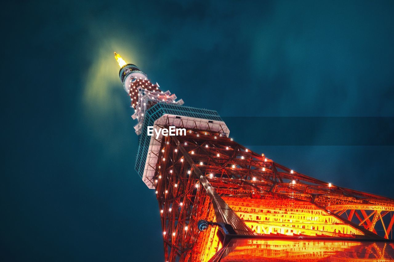 Low angle view of illuminated tokyo tower against sky at night
