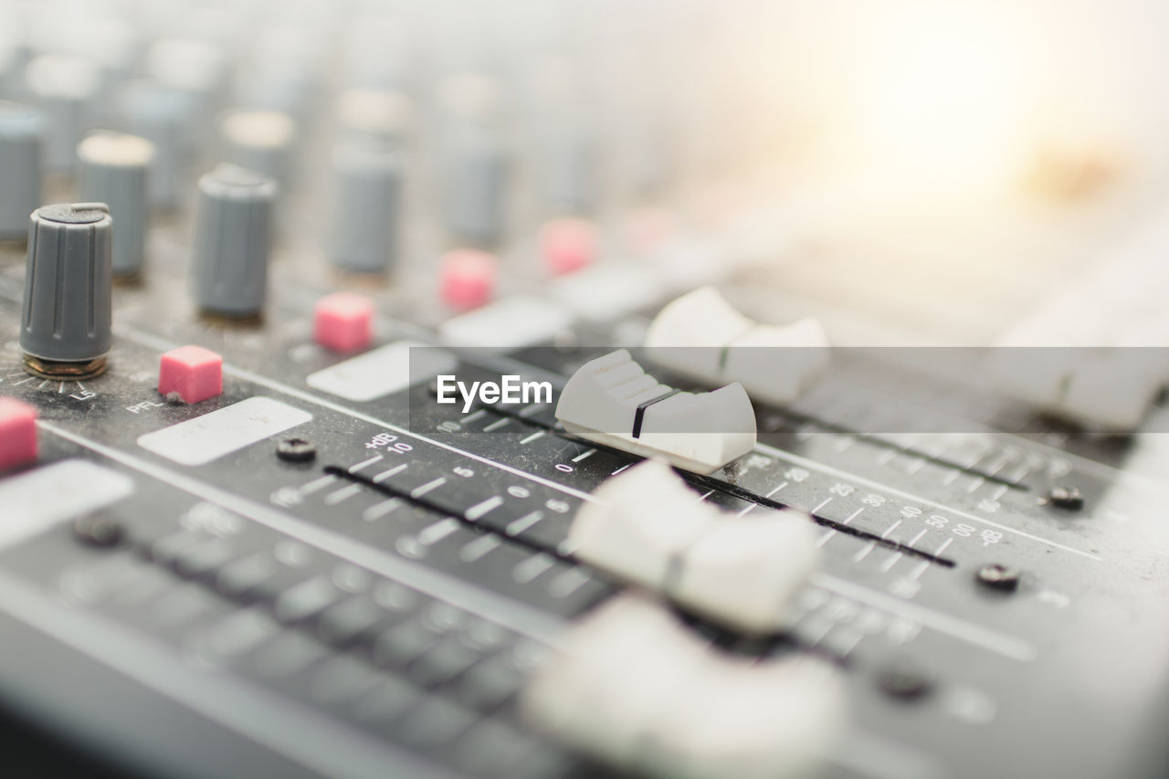 CLOSE-UP OF SOUND MIXER AT CAMERA