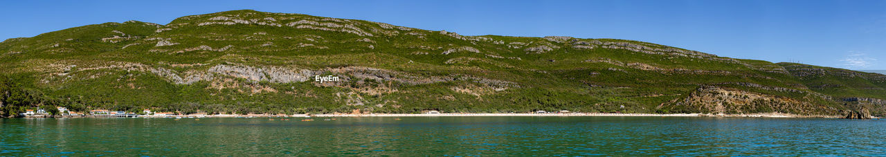Scenic view of sea and mountains against clear sky in portugal