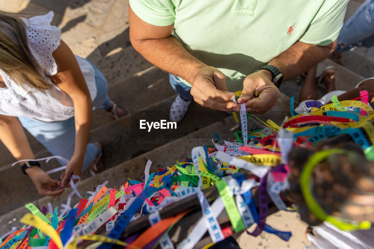 adult, men, business, occupation, business finance and industry, multi colored, working, small business, two people, women, art, craft, high angle view, retail, clothing, selling, market, selective focus, person, female, casual clothing, togetherness, holding, day