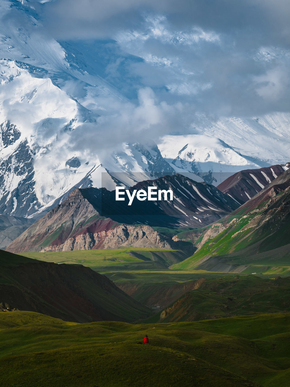 Scenic view of field and mountains against sky