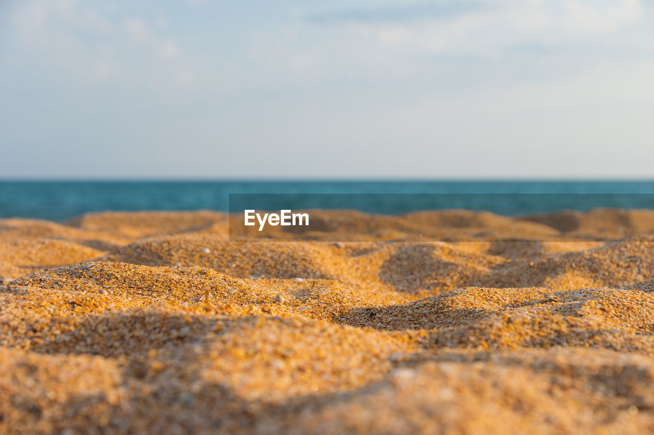 sand, sea, land, horizon, sky, beach, water, shore, horizon over water, beauty in nature, coast, nature, scenics - nature, tranquility, natural environment, cloud, ocean, tranquil scene, no people, rock, day, selective focus, morning, sunlight, body of water, outdoors, wave, idyllic, field, soil