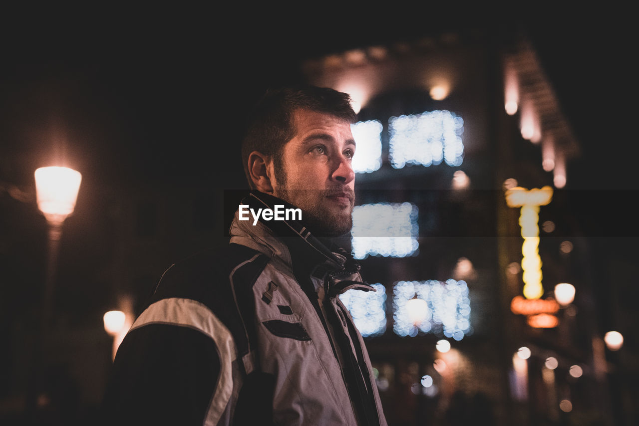 Man looking away at night
