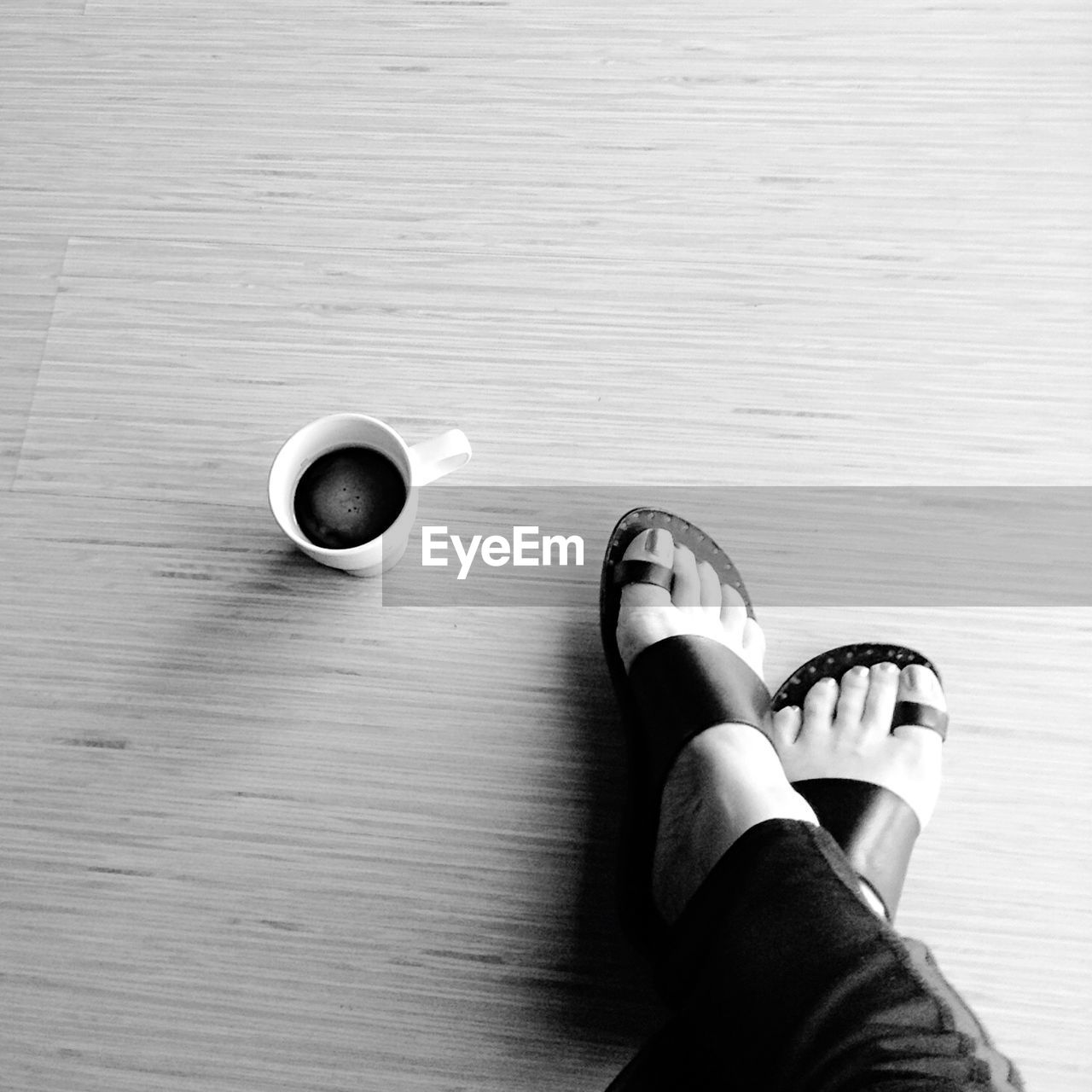 LOW SECTION OF WOMAN STANDING ON TILED FLOOR