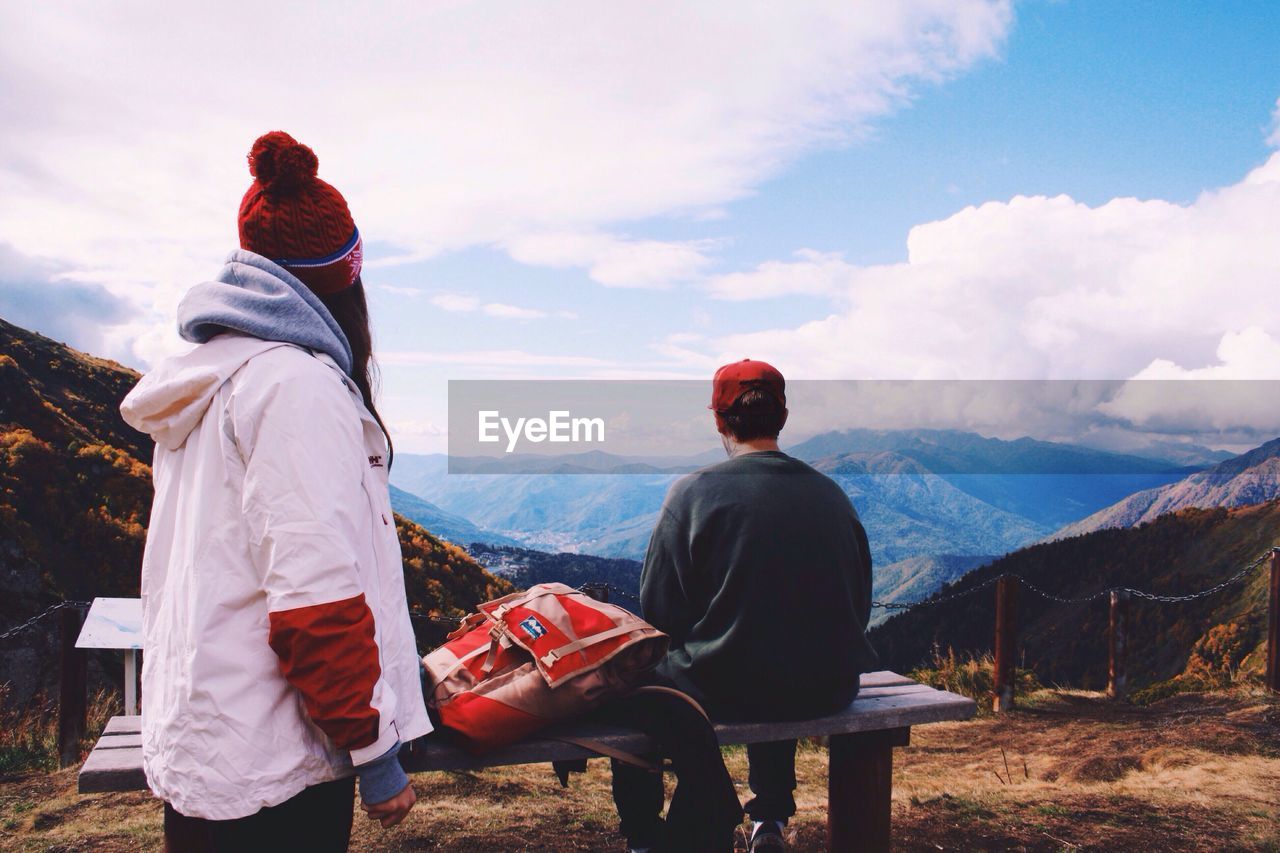 Friends on mountains against sky