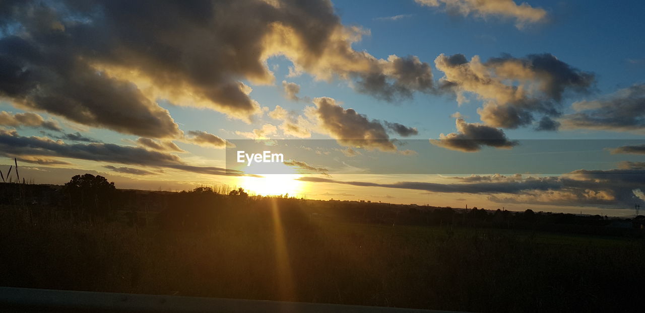 SILHOUETTE OF LANDSCAPE AGAINST SUNSET SKY