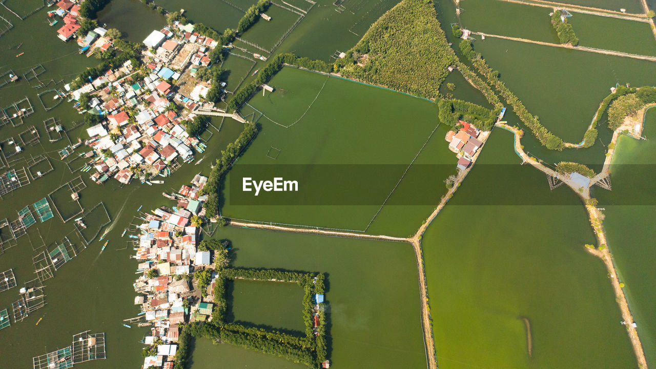 Aerial view of fishing village among fish farm ponds. philippines.