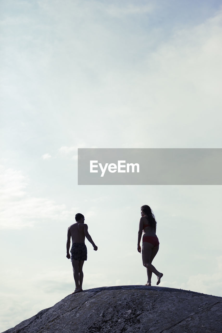 Silhouette of couple on rock