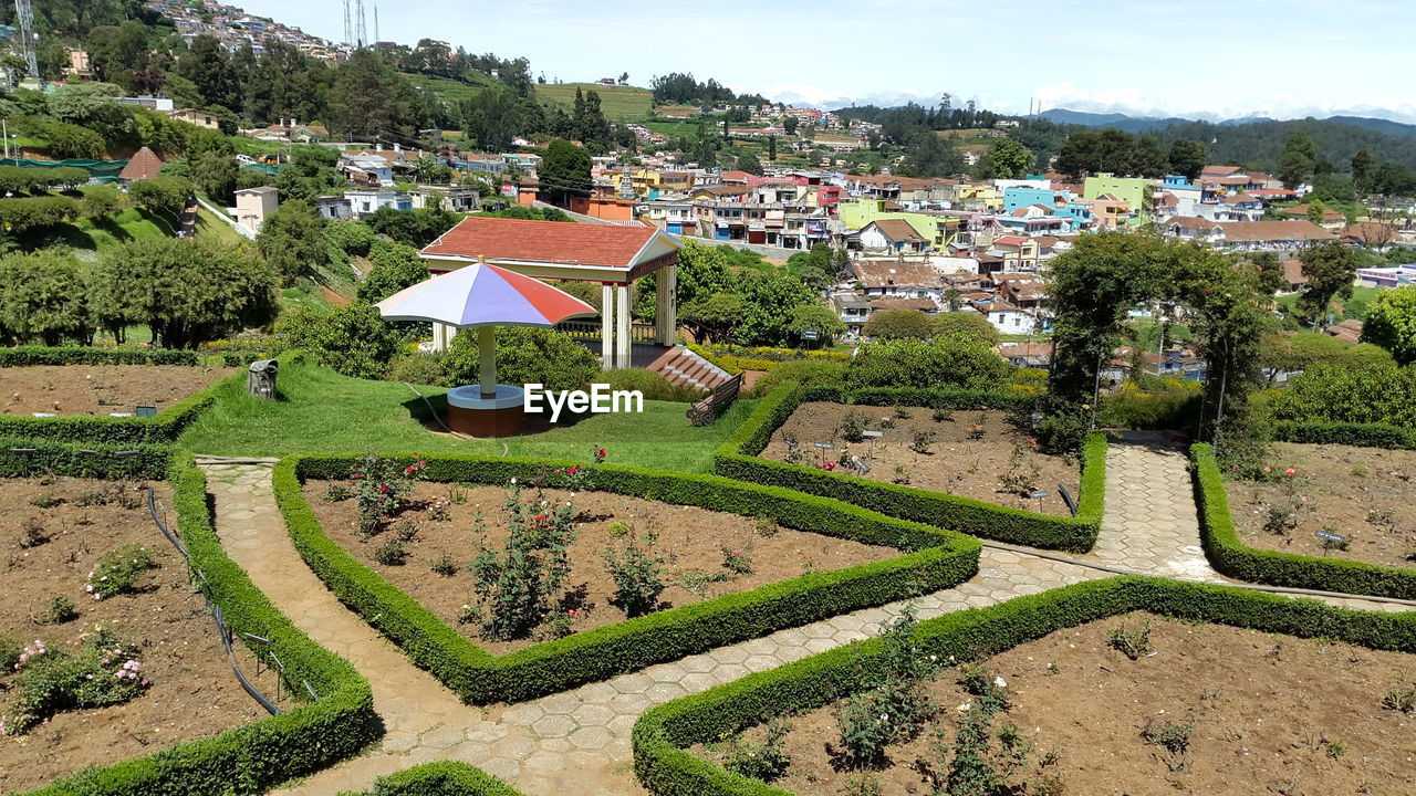 High angle view of park against houses in village