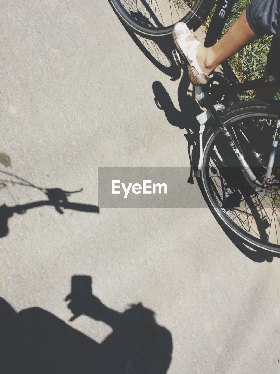 Low section of person riding bicycle on street