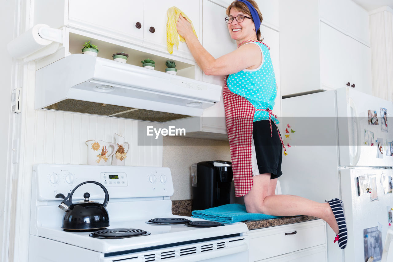 WOMAN STANDING IN FRONT OF HOME